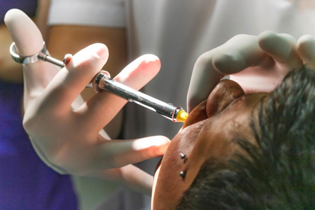 A dentist gives an injection during a procedure in Argentina