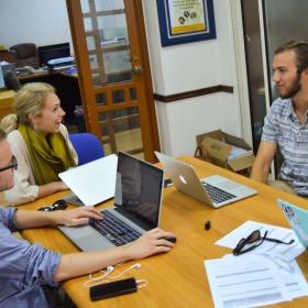A group of Human Rights interns in Africa have a lively discussion while doing research for a case. 