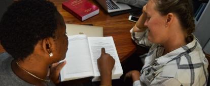 A student is assisted by a Projects Abroad staff member during her Human Rights internship in Tanzania.