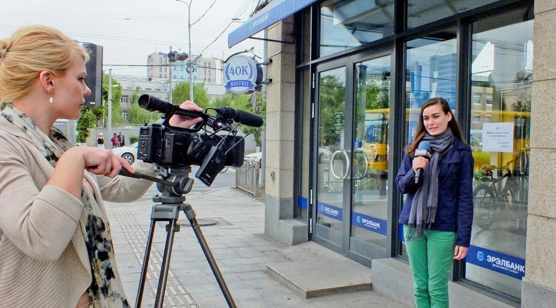 An intern prepares for an interview on camera during one of our Journalism internships abroad.