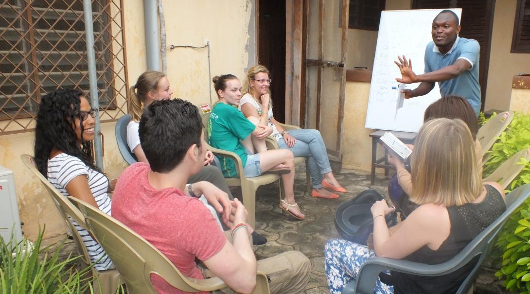Volunteers listen intently to their dedicated tutor to help them learn a language abroad.