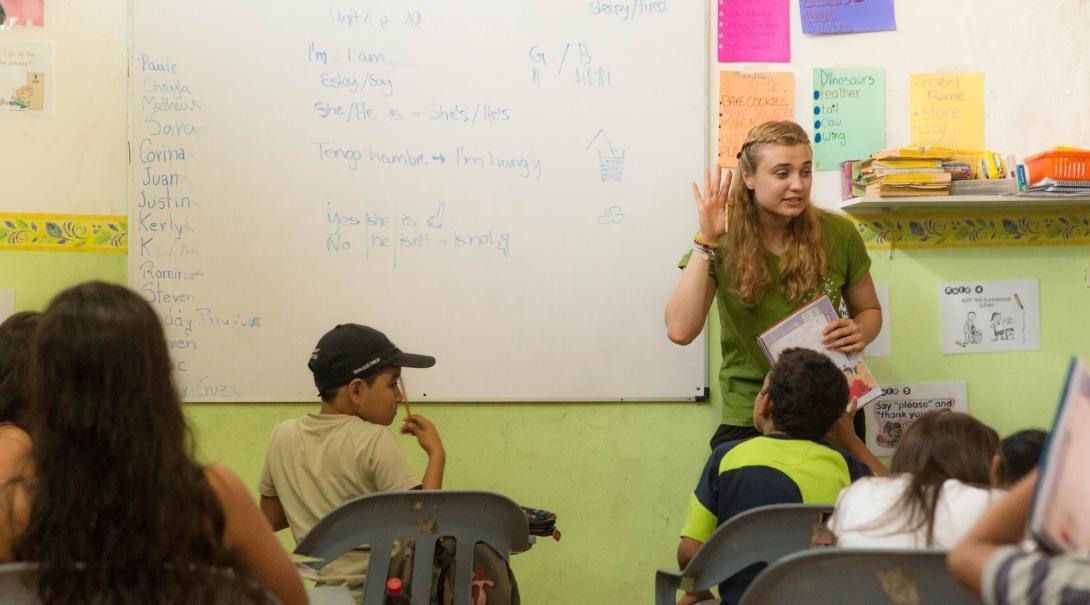 A volunteer teaching abroad works with students on a Projects Abroad placement.