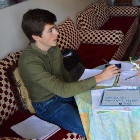 Projects Abroad volunteer goes through his Arabic homework given to him during the language lessons.
