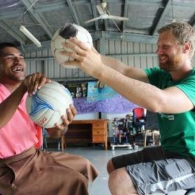 A graduate doing a Physiotherapy internship abroad works with a patient during a treatment session in Samoa.