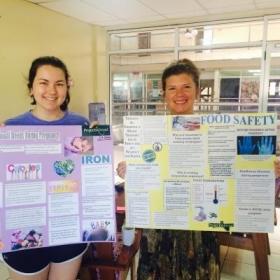 A pair of students doing Nutrition internships abroad with materials they prepared for an education and awareness campaign in local communiities.