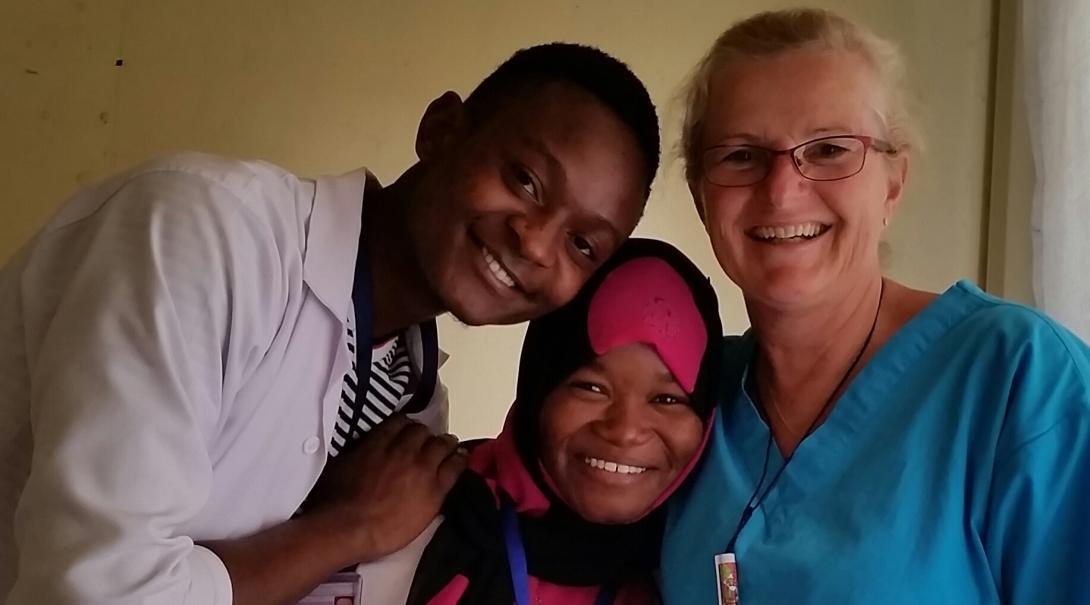 Tanzanian medical professionals spend time with a nurse volunteering abroad for her career break. 