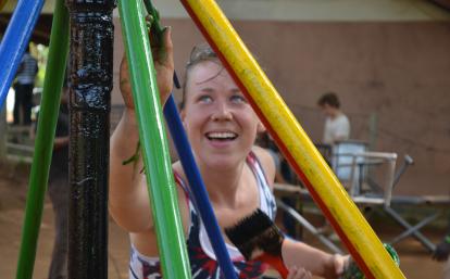 A Projects Abroad construction volunteer in Ghana painting a playground.