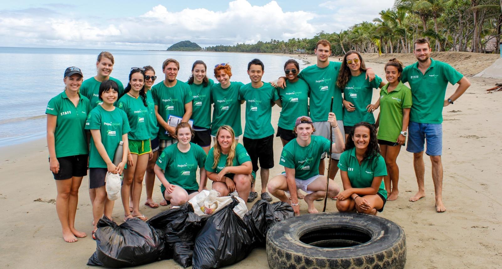 Projects Abroad volunteers pose after a successful beach clean up in Fiji