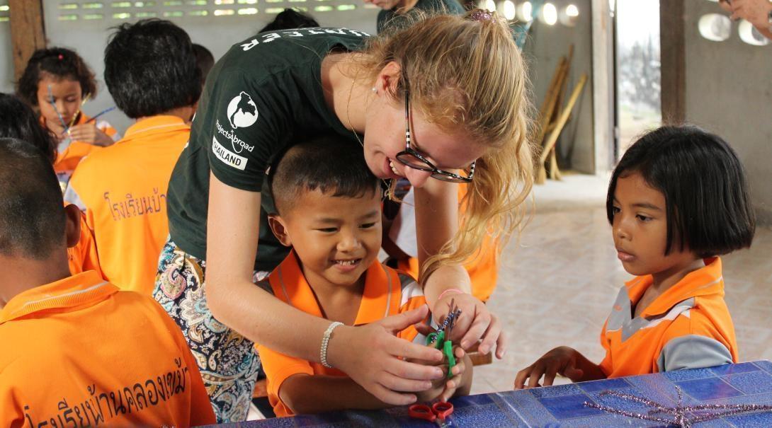 Care volunteers looking after school children in Thailand