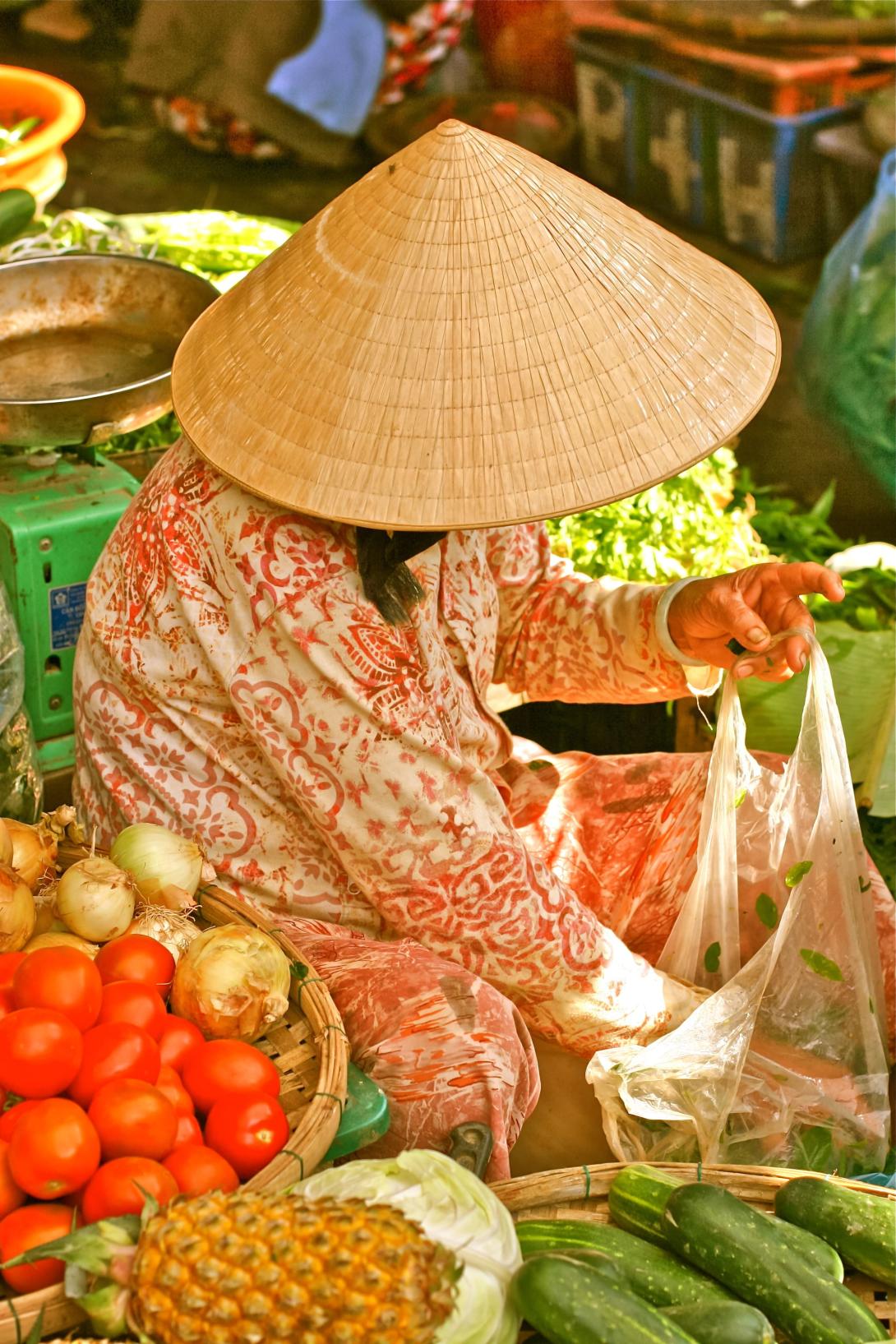 Hanoi street market vendor selling fruit and vegetables